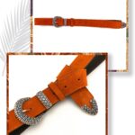 Orange suede leather belt with an embossed silver metal buckle and loop