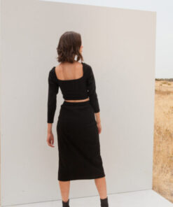 Side profile showing the button details and front slit of the Melane Black Skirt – Mallory The Label collection at IGO Pr