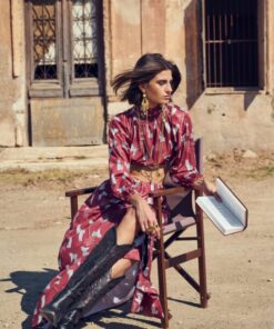 Model wearing Crimson Martini Skirt by Atheras Clothing, seated outdoors