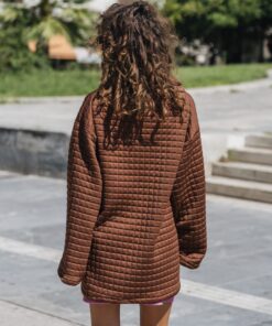Model wearing The Wait Sweatshirt – oversized brown quilted design from behind