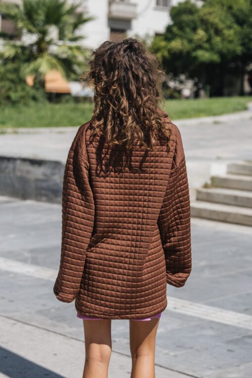 Model wearing The Wait Sweatshirt – oversized brown quilted design from behind
